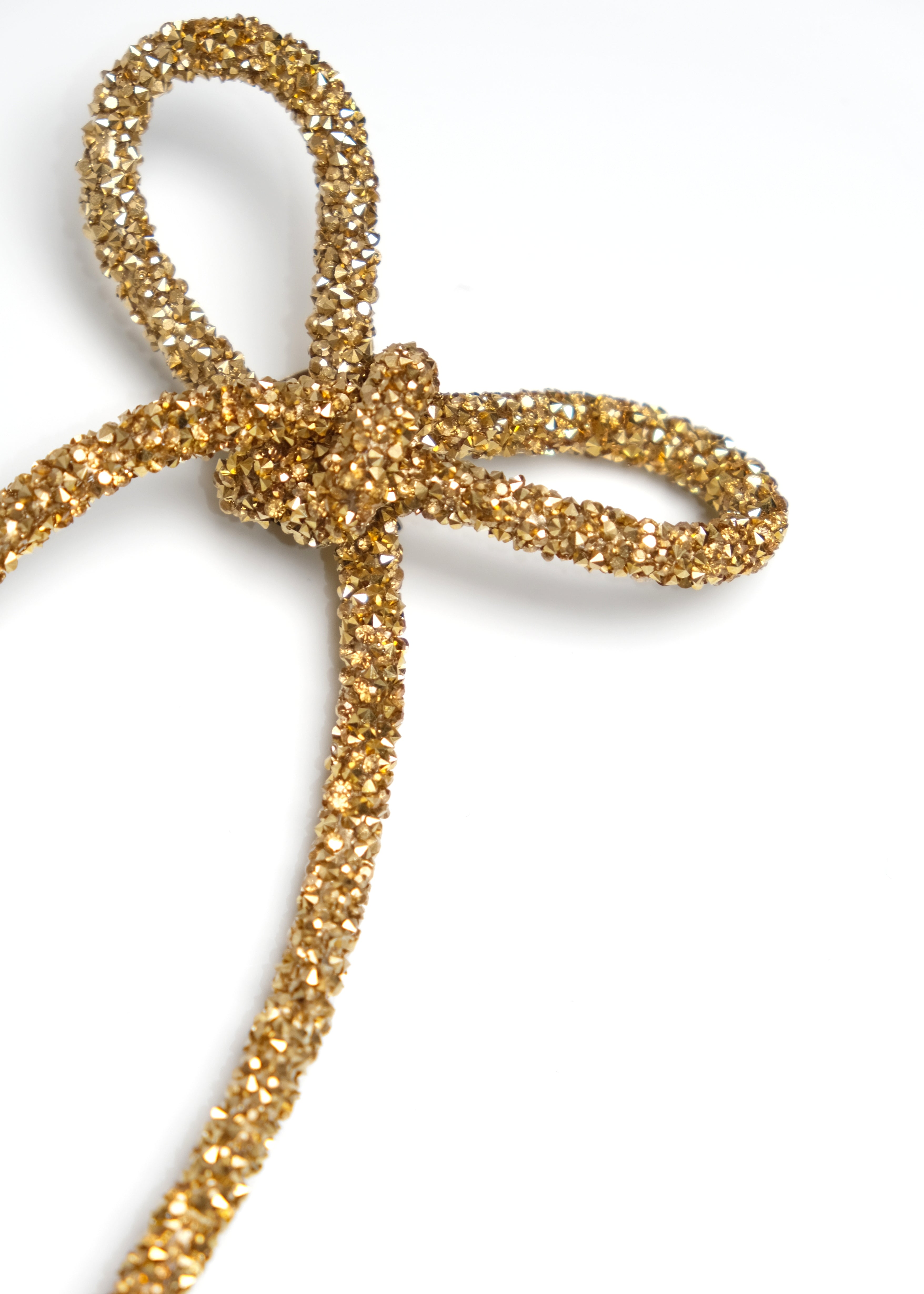 Gold glittery bow on a white background