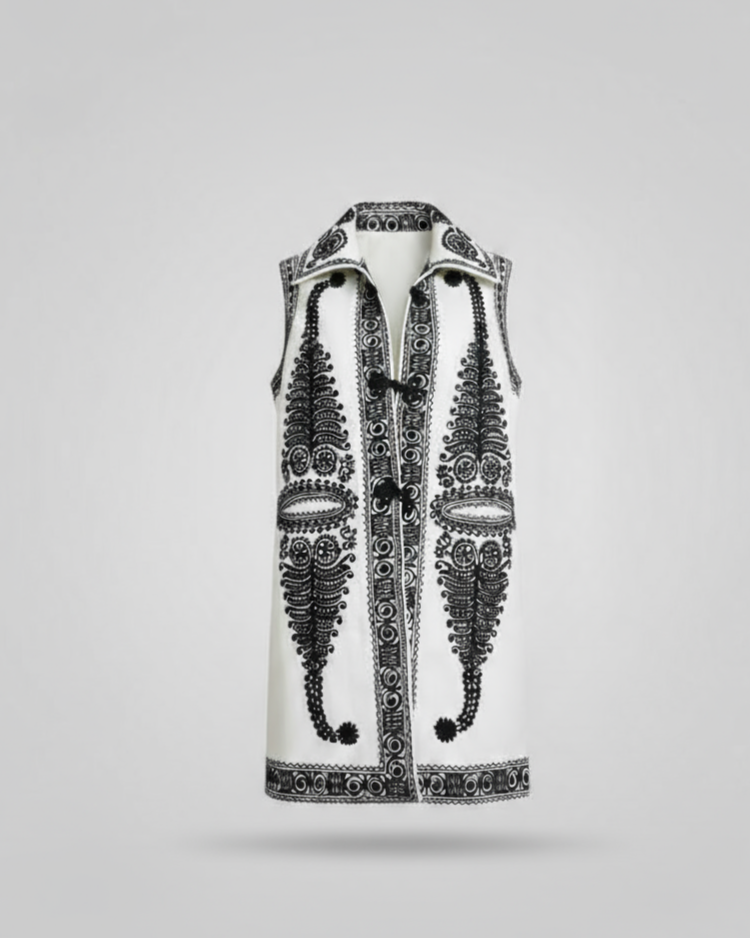 Decorative vest with intricate black patterns on a light gray background