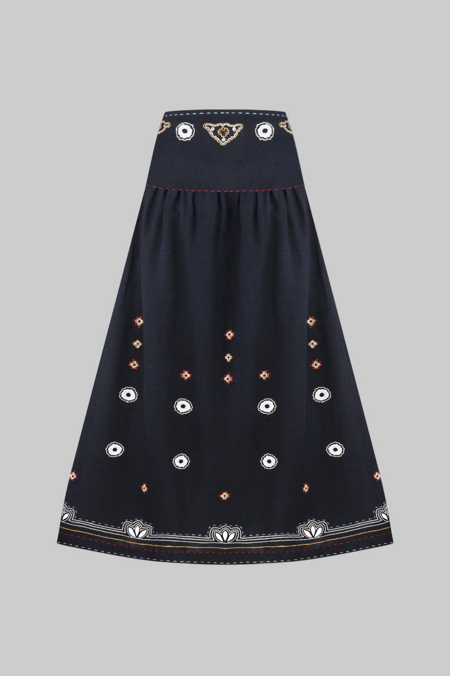 Navy blue skirt with decorative patterns on a white background